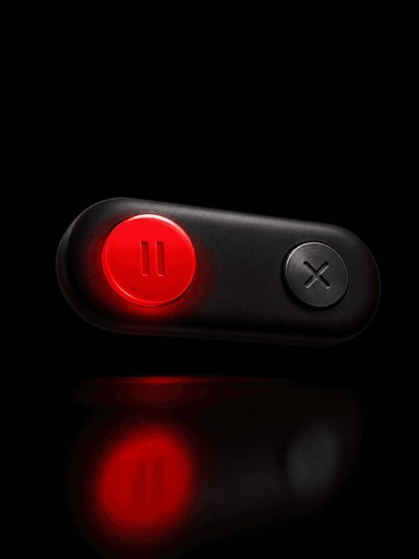 A black toggle switch with a glowing red button on a dark background, suggesting it's in the "on" position.