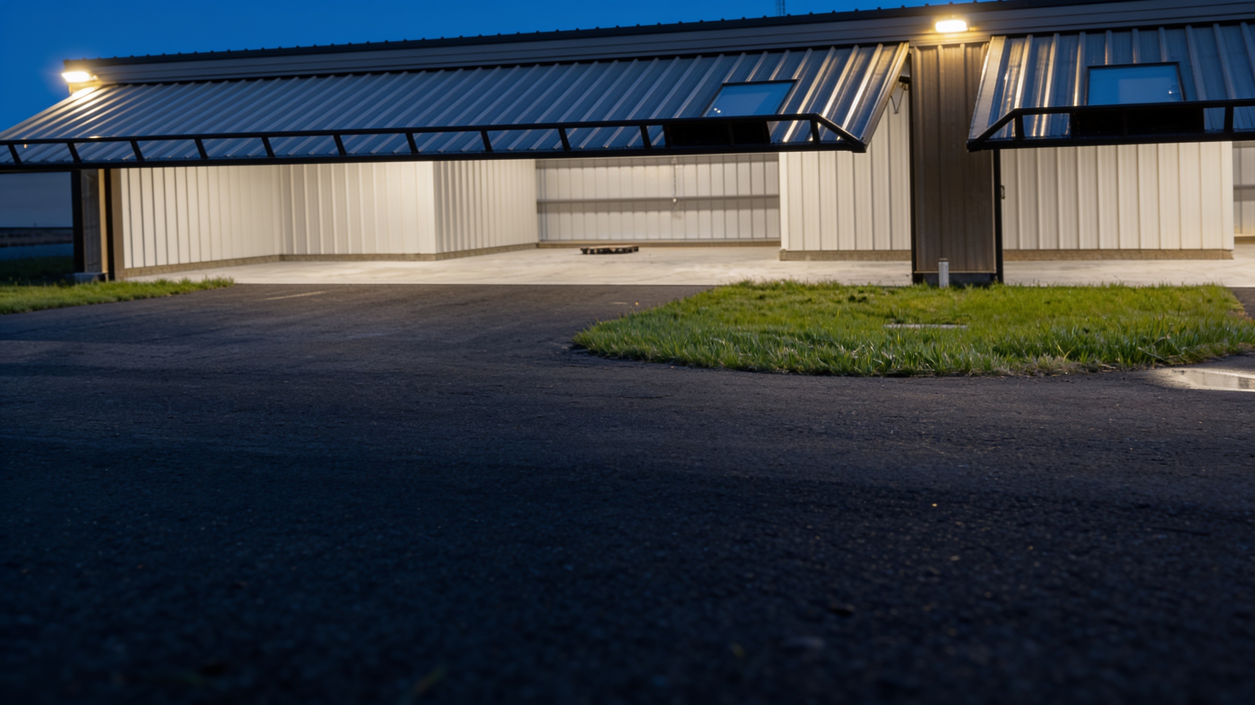 Illuminated T-hangar with open PowerLift hydraulic aircraft hangar doors