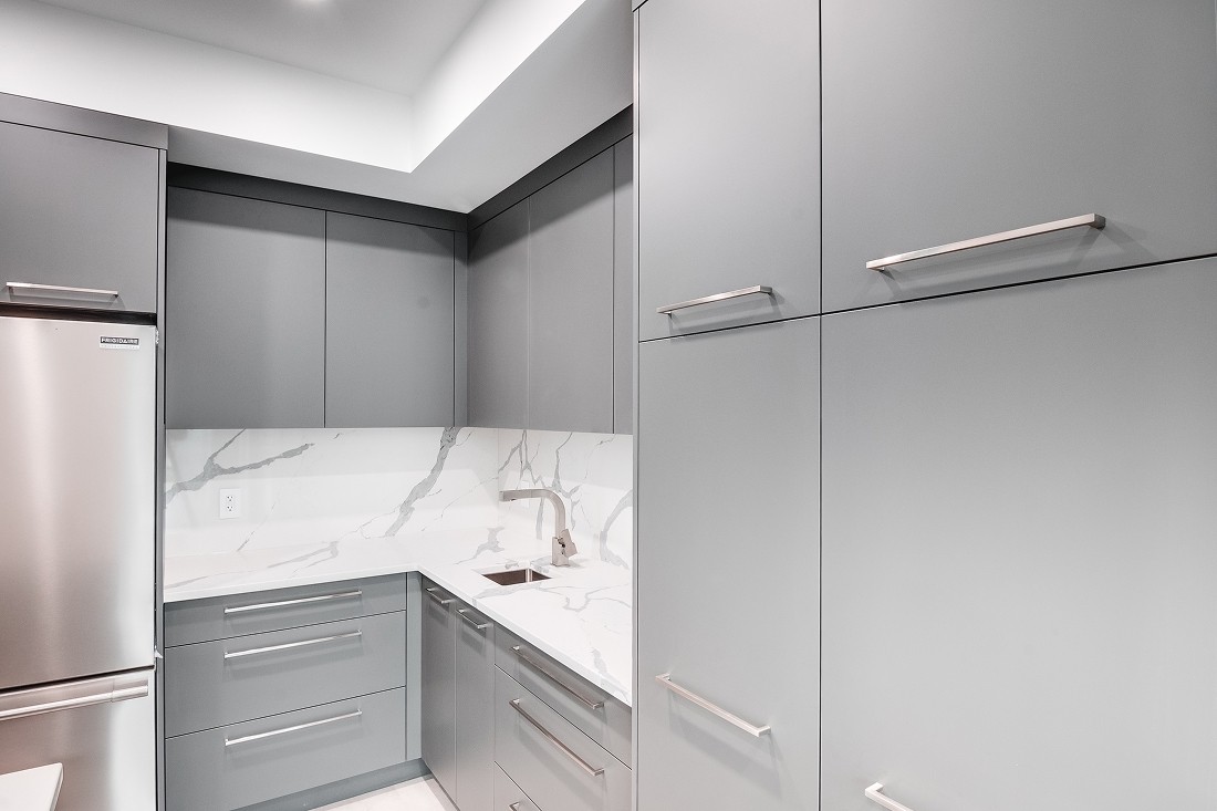Corner pantry cabinets with chrome handles