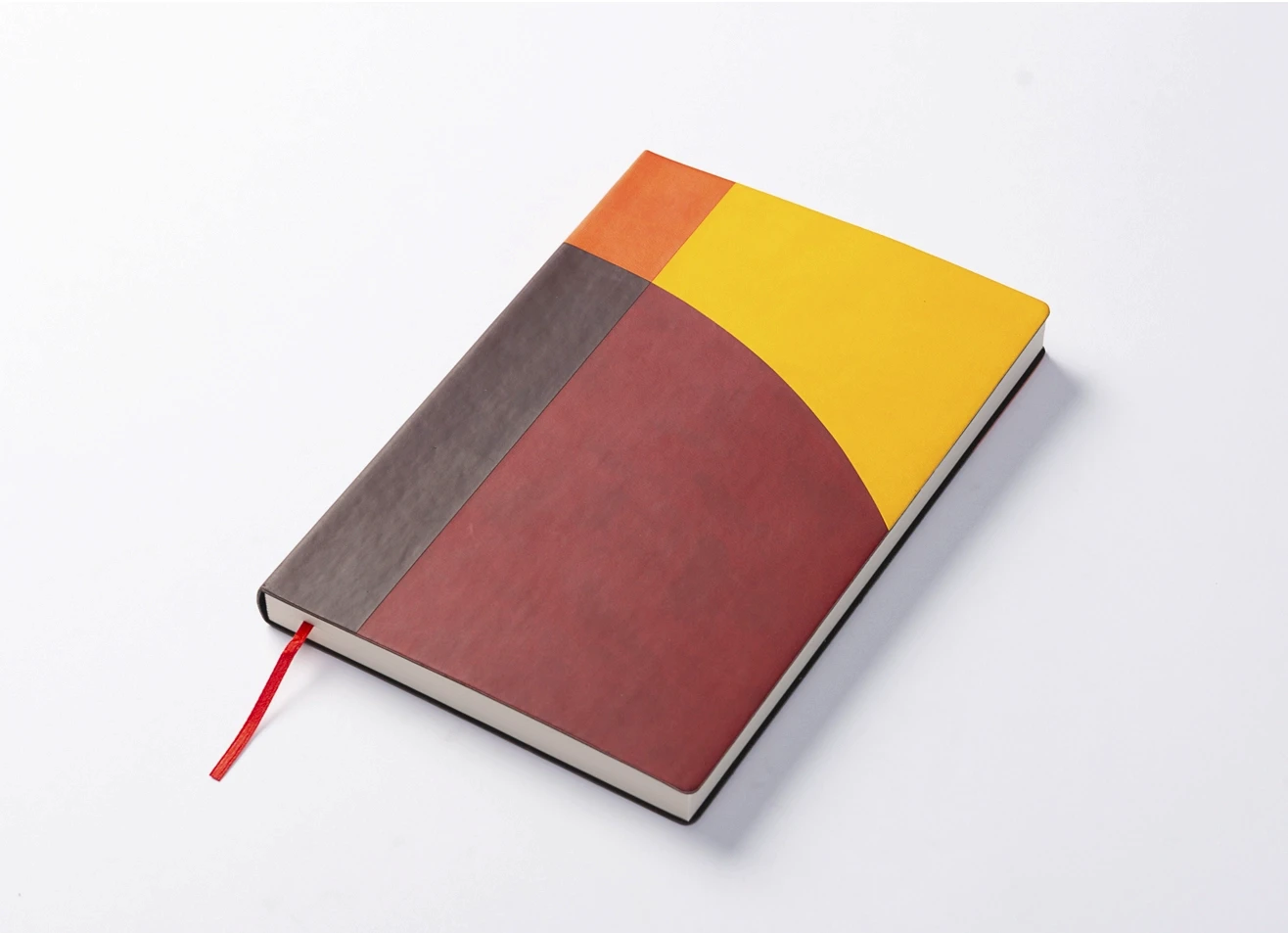 Angled view of multicolor geometric notebook.
