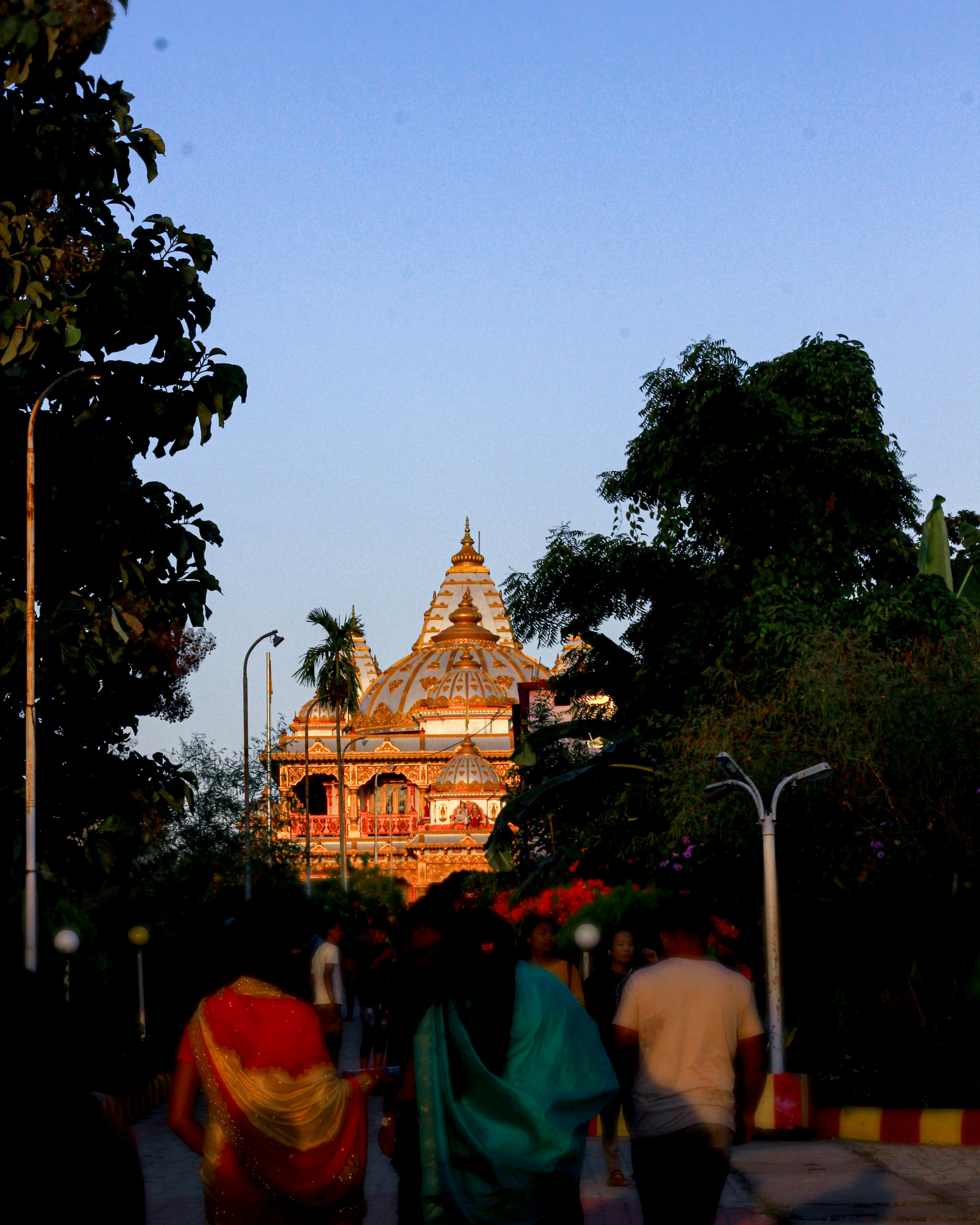 people walking on street towards brown mosque