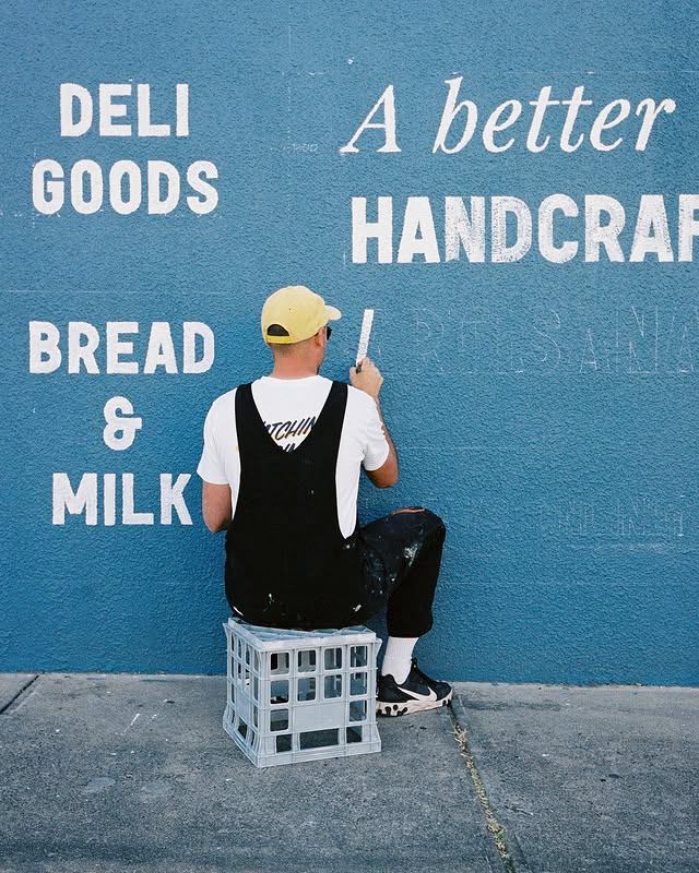 Gastón painting a mural