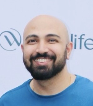 man in gray crew neck t-shirt and gray shorts sitting on basketball court