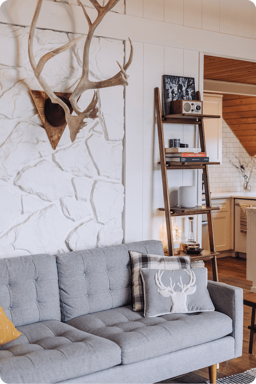 Modern marble shower featuring large format tiles, brass rainfall showerhead, handheld sprayer, and built-in seating bench