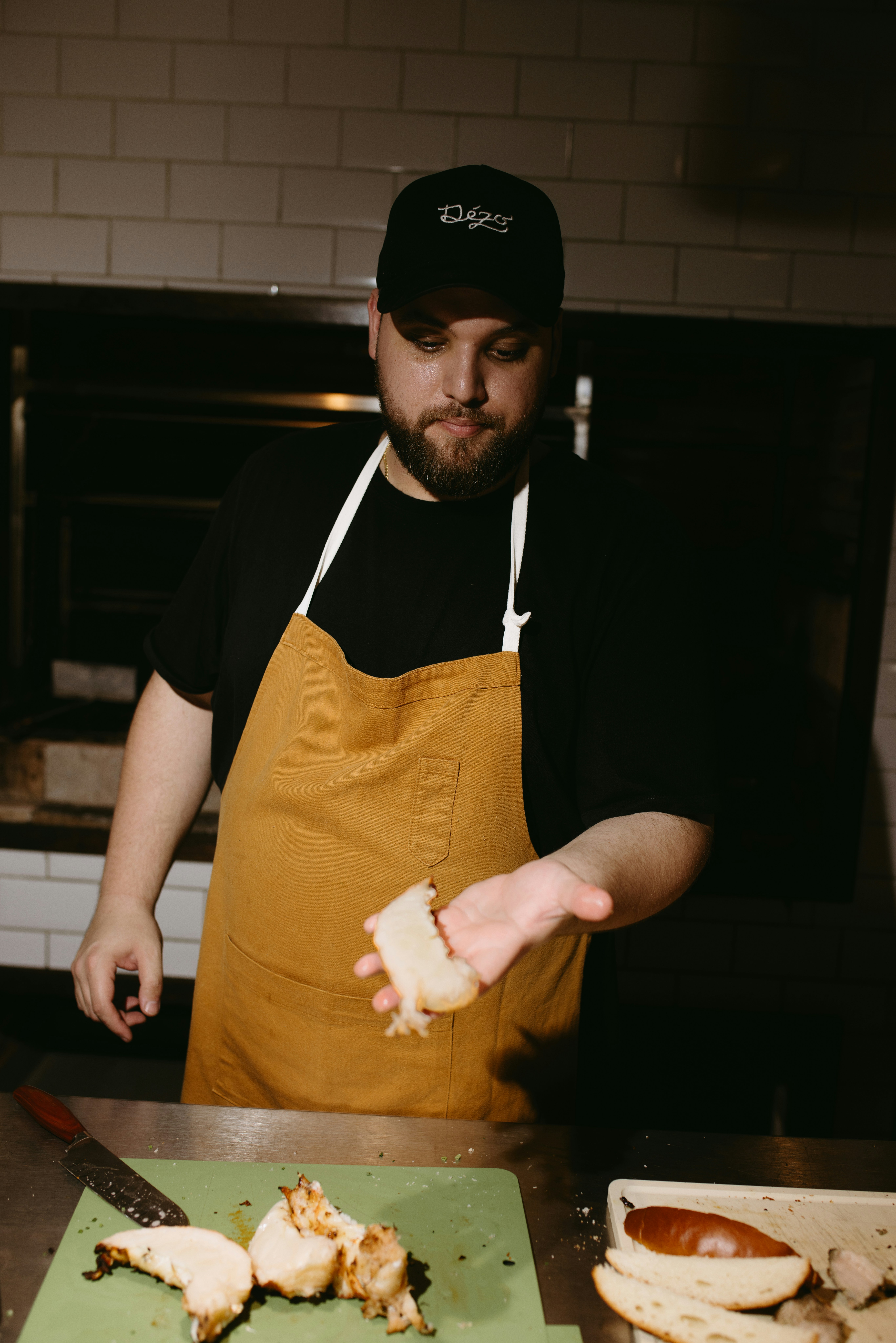 A man in an apron preparing food in a kitchen