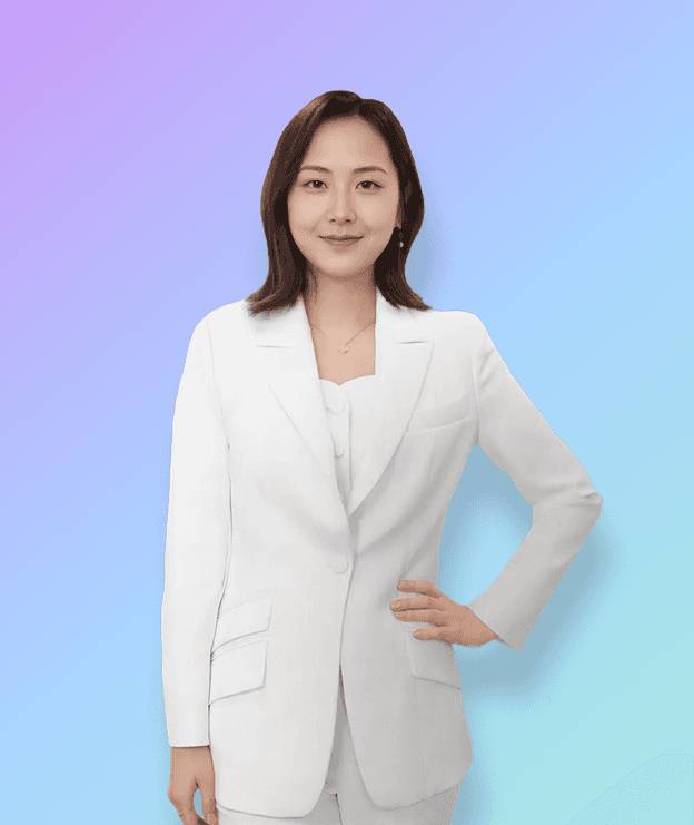 A woman in a white suit stands confidently against a bright red background, smiling with one hand on her hip.