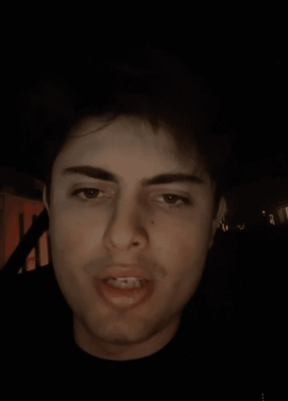 A man works on a laptop in an office.