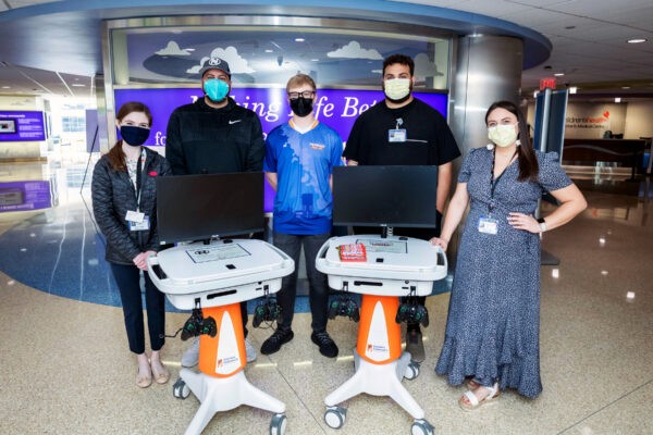 Truman delivering a GO Kart to Dallas Childrens hospital with hospital staff.