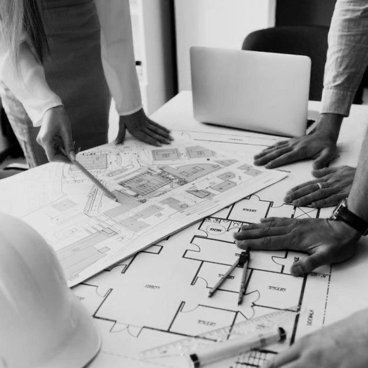 seven construction workers standing on white field