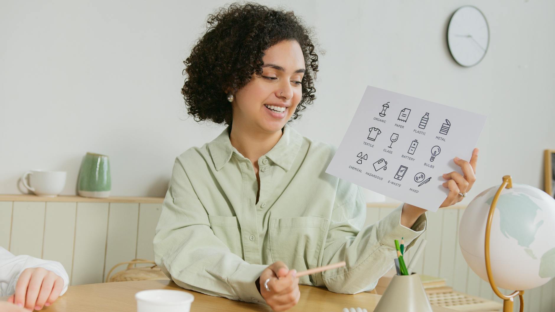 A close-up of a teacher's hand writing a mnemonic acronym on a bright whiteboard.