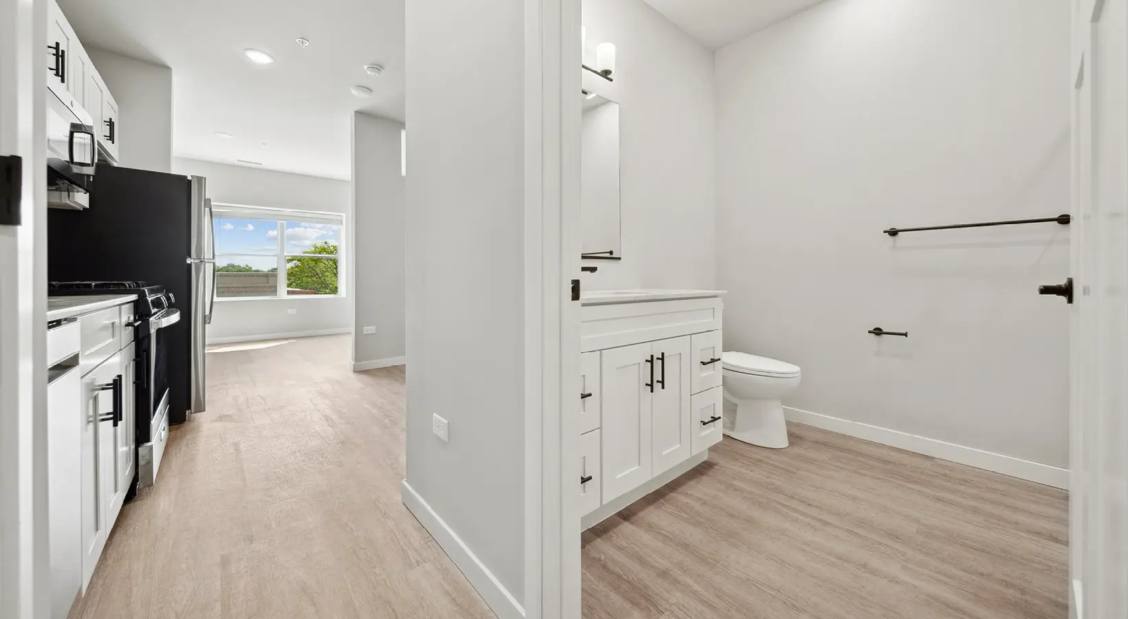 A sleek, modern kitchen with upscale finishes and high-end cabinetry in The Hartford Apartments, Homewood, IL.