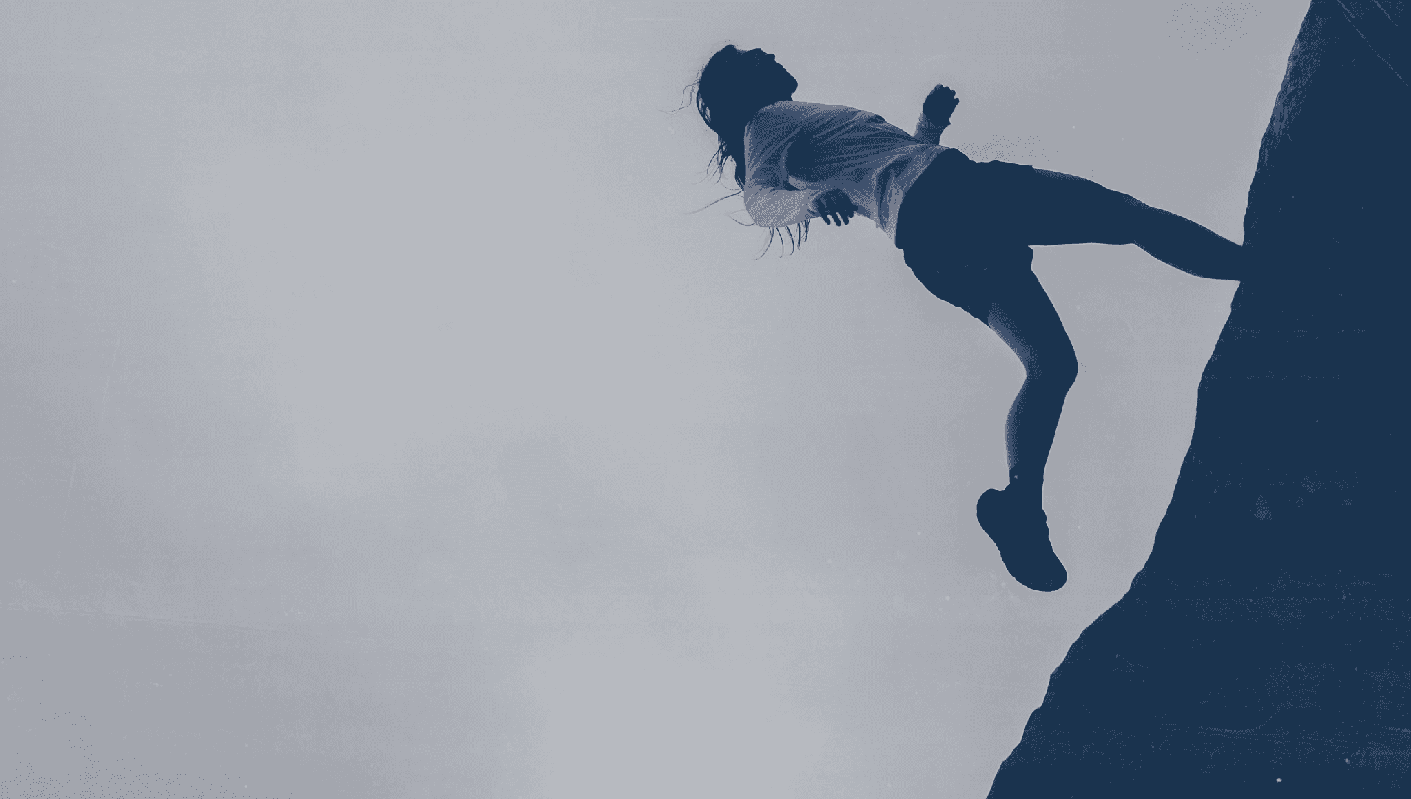 horizontal picture of a runner on a rock.