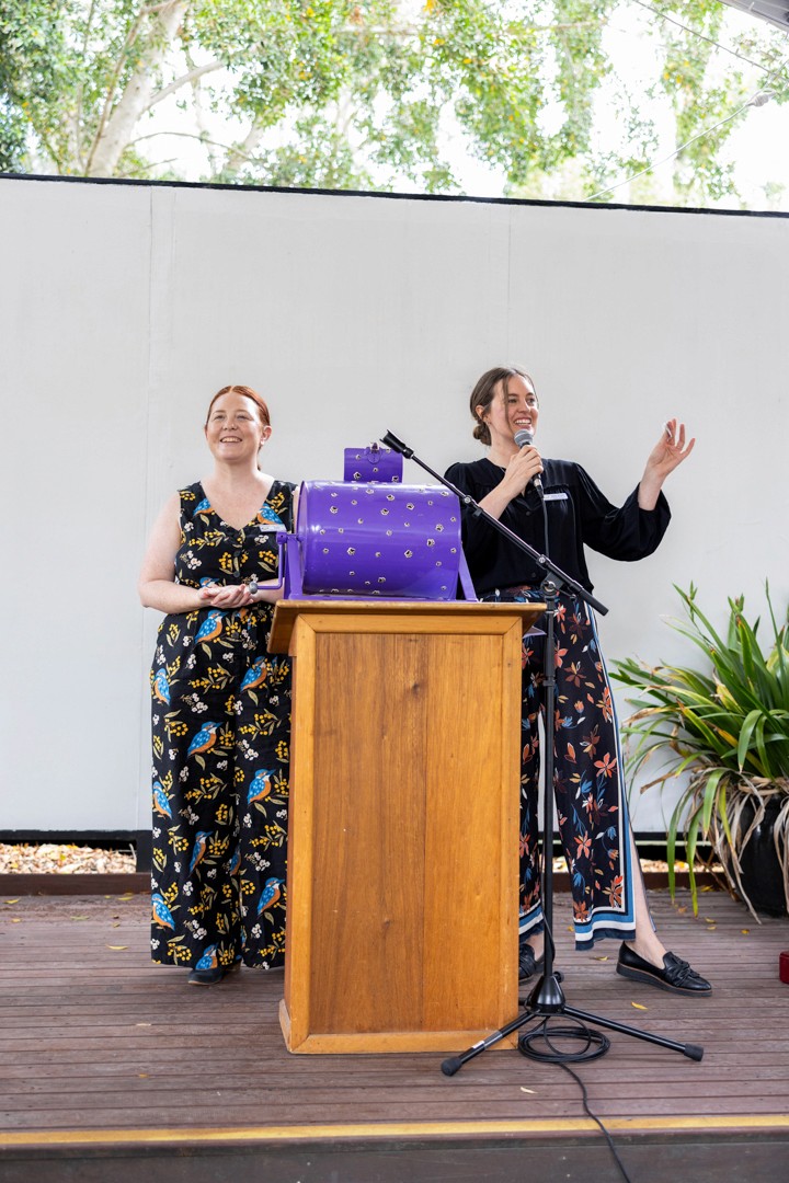 Two women speaking at podium