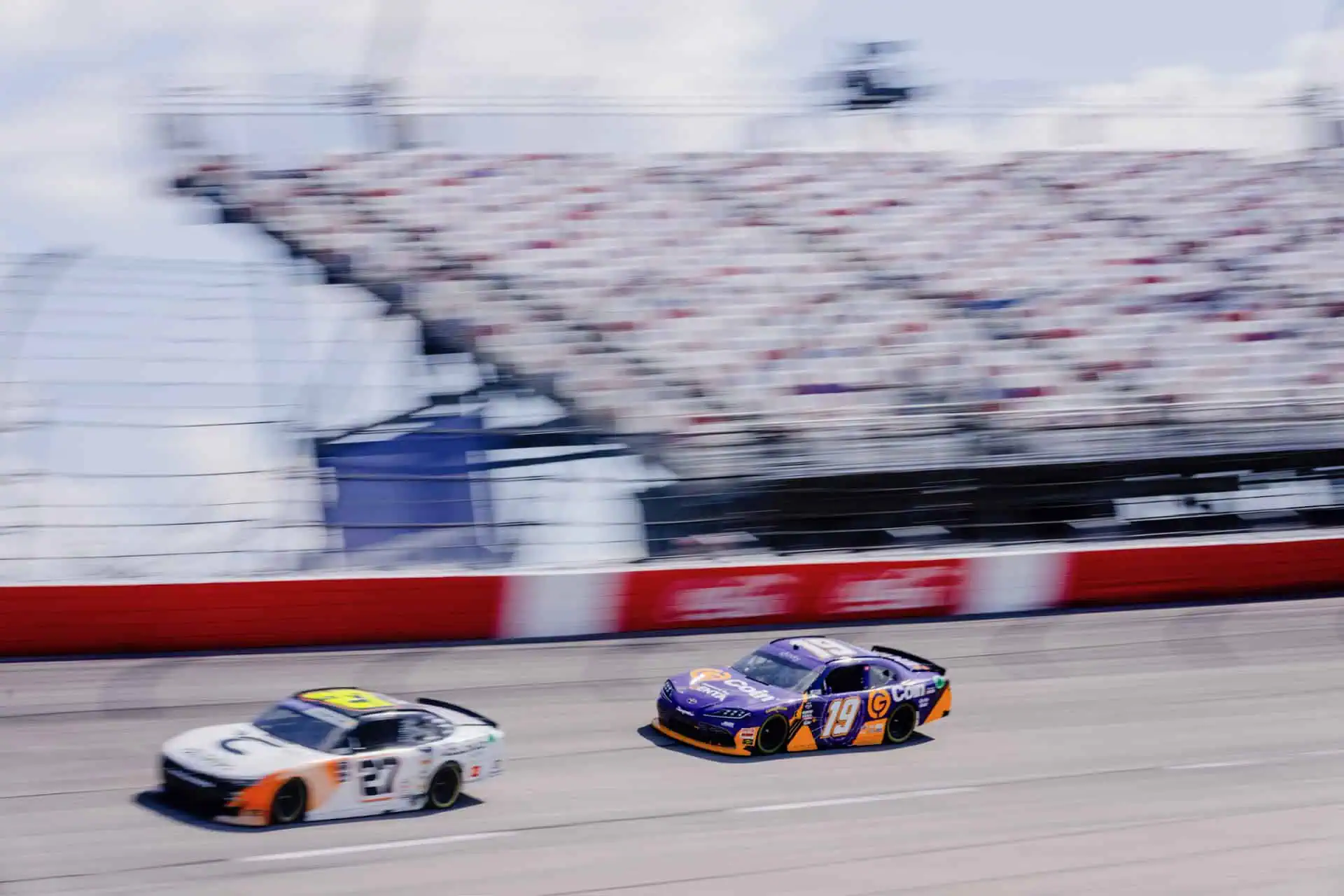 Joe Graf Jr.’s No. 19 NASCAR Xfinity Series car racing side by side with another car on the track.