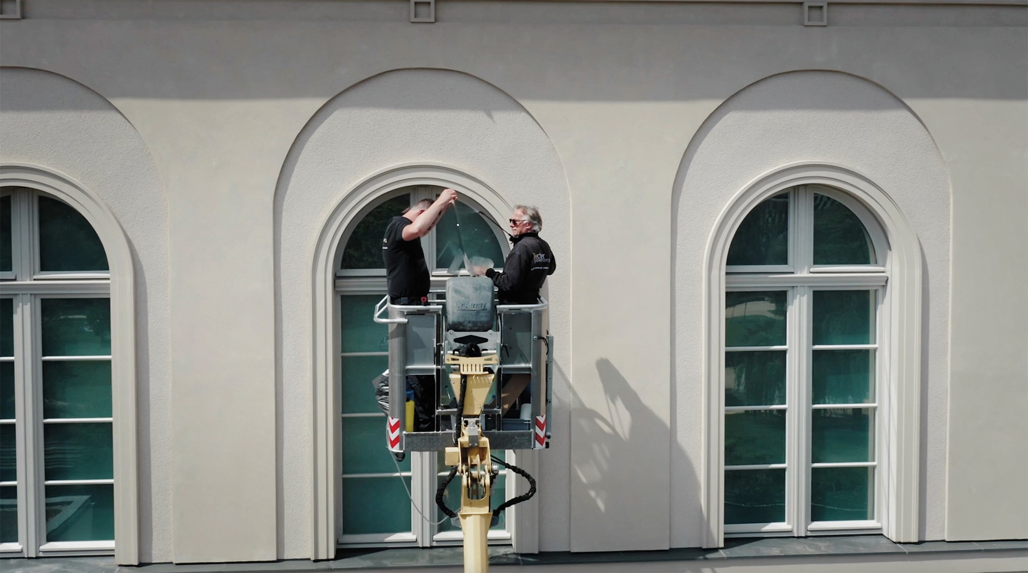 Zwei Monteure arbeiten an einer Fensterscheibe