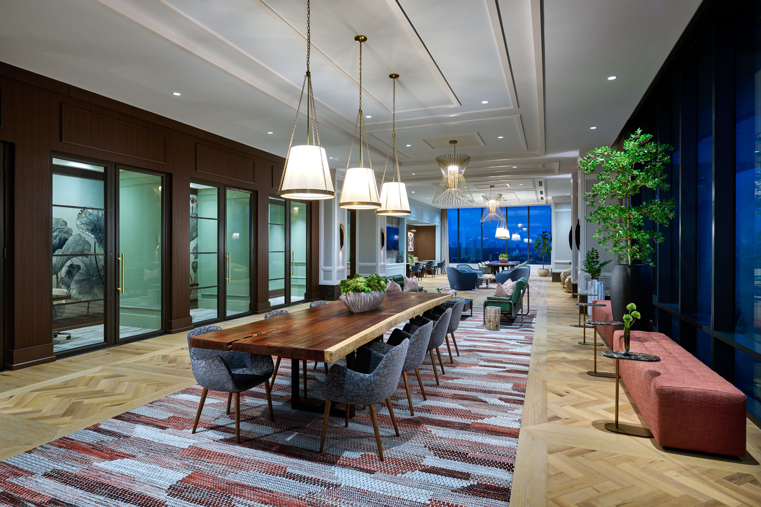 Modern lounge with live-edge wood table and large windows.