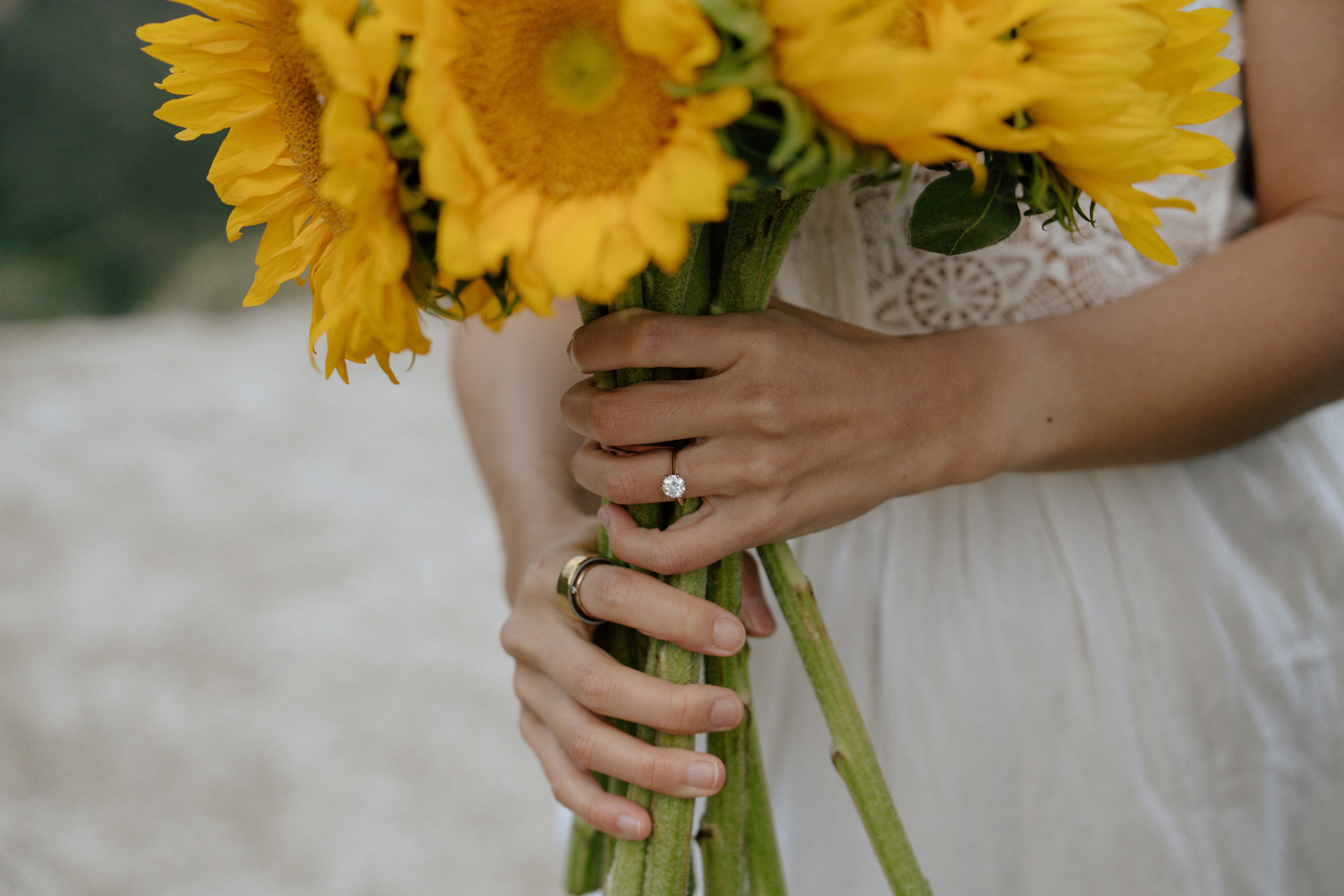 A beautifully set dining table with white tablecloth, cutlery, and fresh greenery in a cozy, well-lit space.