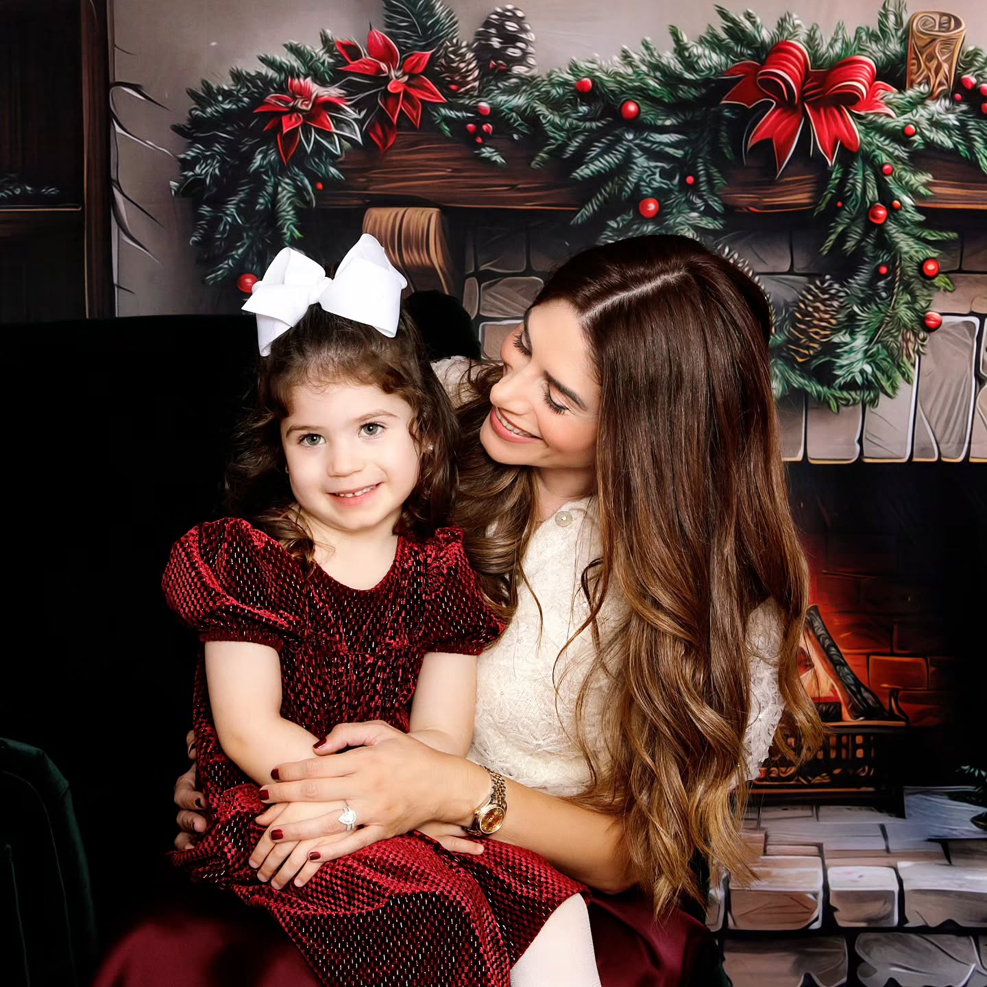 A mother and daughter session during a professional Christmas photoshoot, featuring a festive set up for Christmas photos.