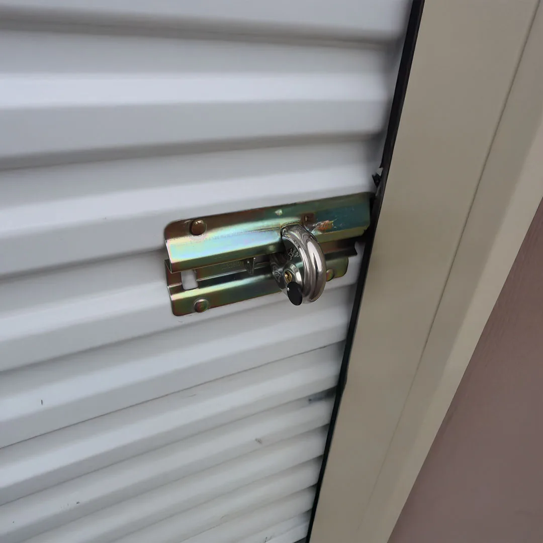 Padlock securing a roll-up storage unit door