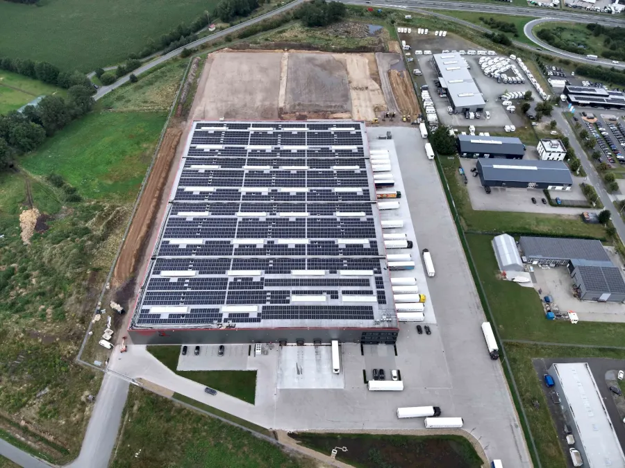 Großes Lager mit Dach-Solaranlage und vielen LKWs, Luftaufnahme
