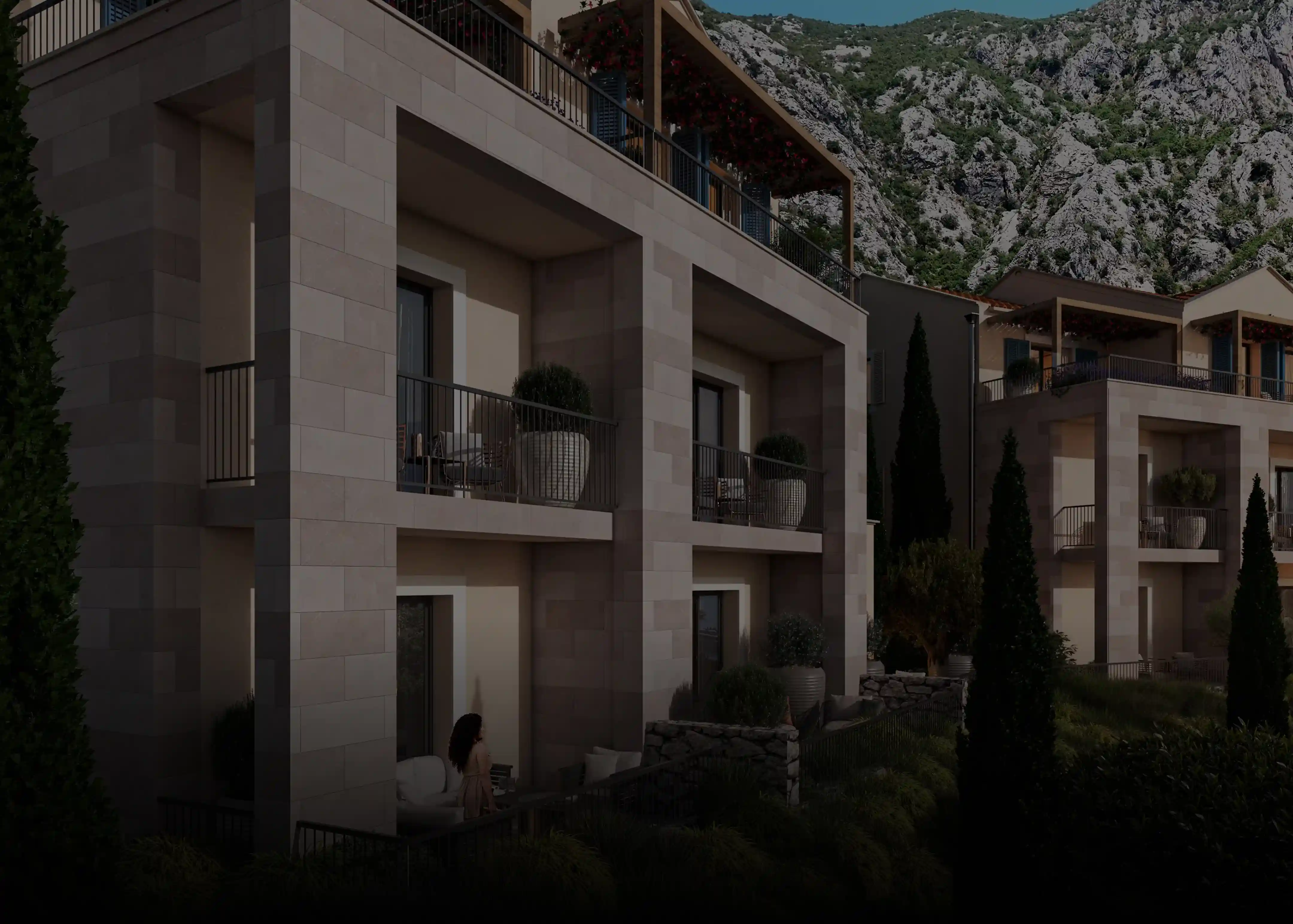 Close-up view of Mediterranean-style residence with balconies, blue shutters, and landscaped gardens.