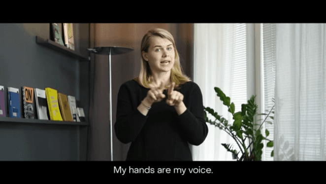 a woman gesturing hand-sign language