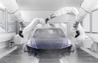 Roboter mit weißen Hüllen während der Lackierung einer Fahrzeugkarosserie