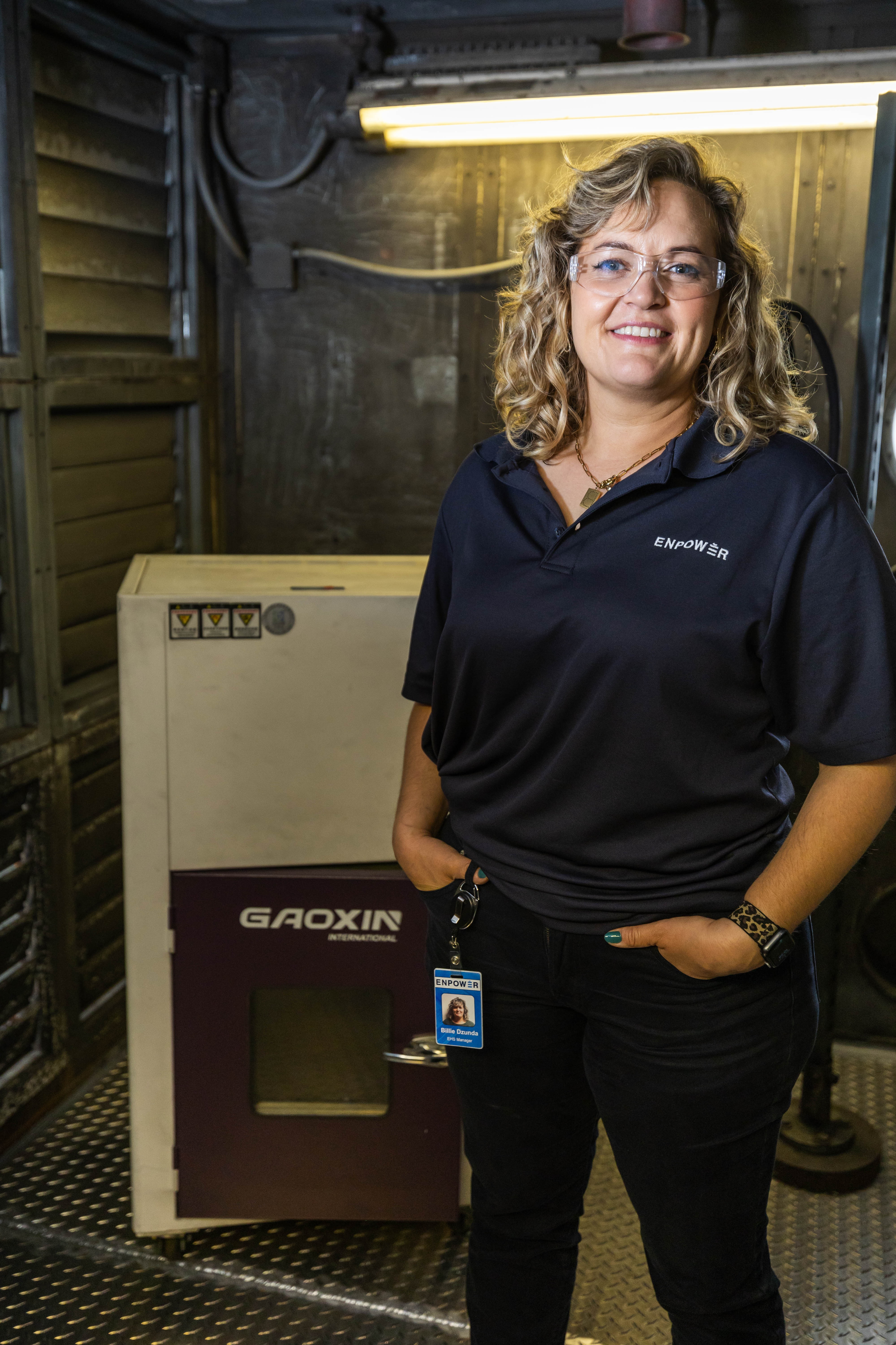 Photo of EnPower Engineer with battery production equipment in background