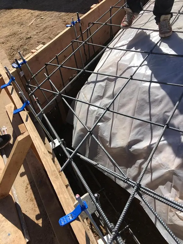 A cell phone sitting on top of a wooden table next to a keyboard