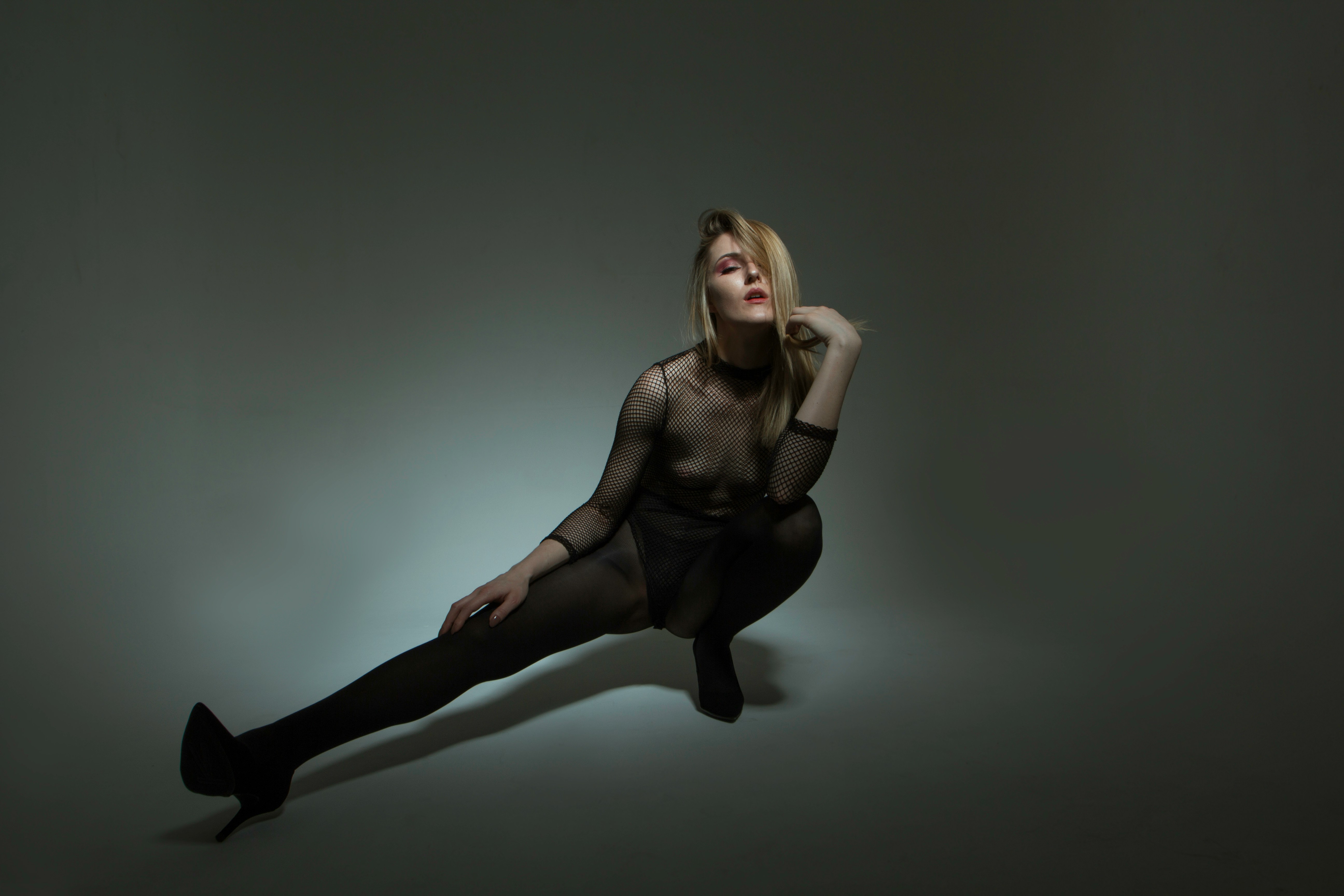 woman in black tank top and black pants sitting on white floor