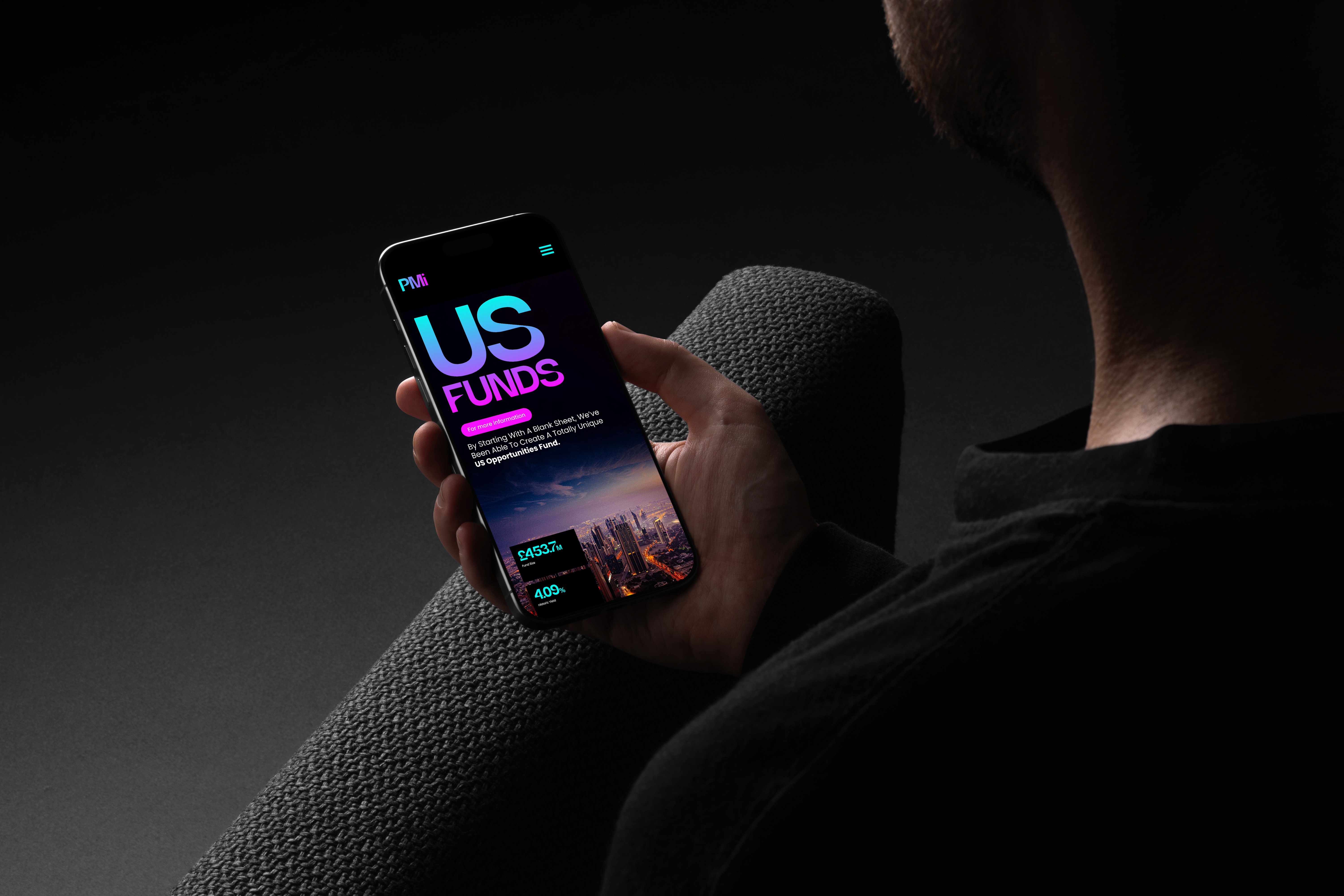 Man holing iPad showcasing Premier Miton web design concept screen.