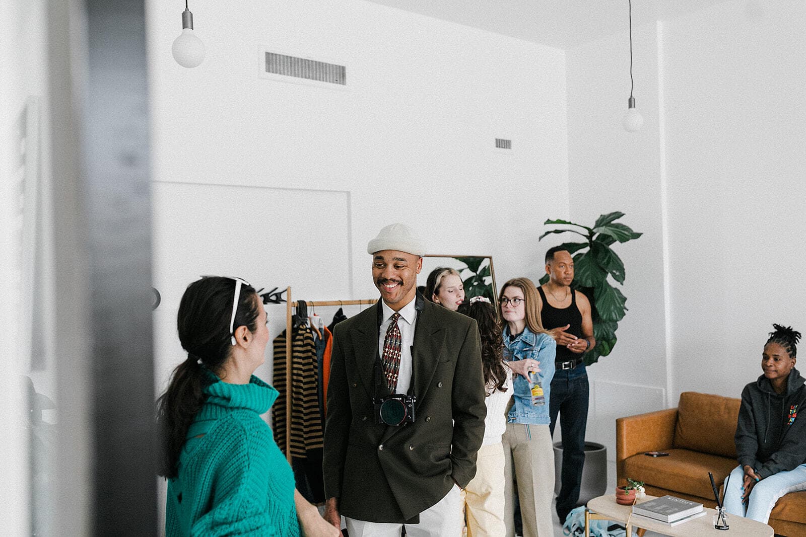 A group of creatives gathers for a photoshoot session at Revelator Studio in Shreveport, a natural light photography studio offering a collaborative space for professionals and influencers.