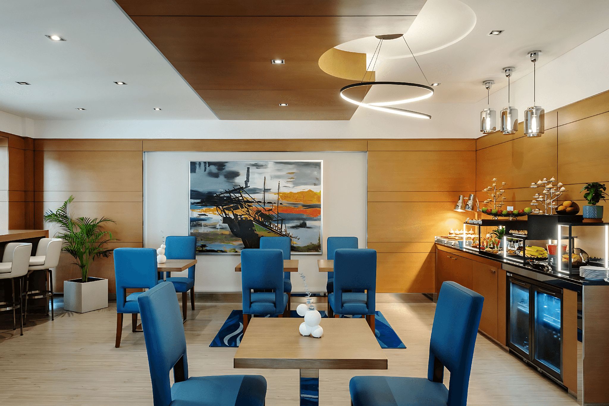 The cafe area of Delta Hotels Jumeirah Beach, featuring blue chairs, beige tables, and a self-service food area.
