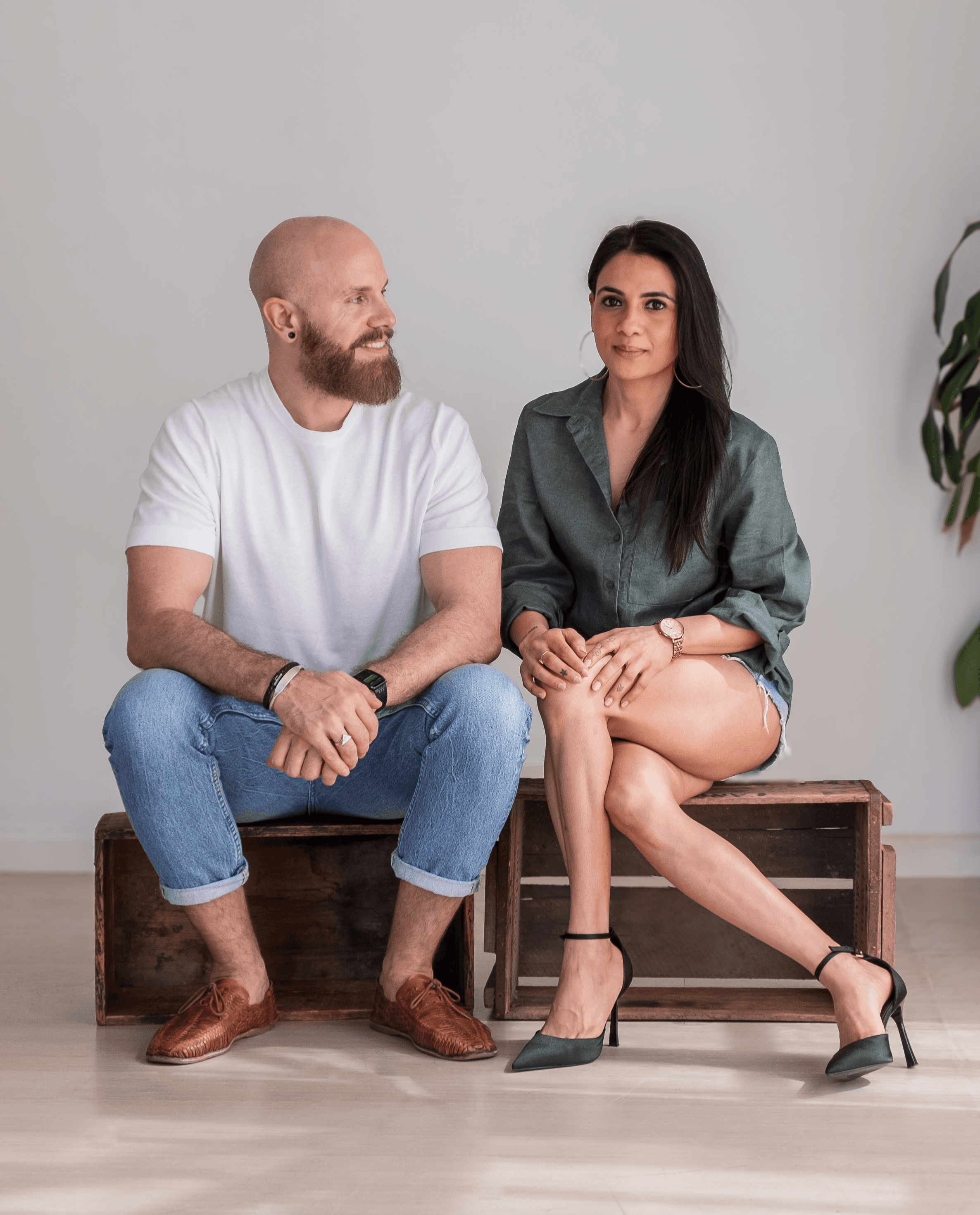 Image of Australian Coffee Culture founder (ACC) Shreya Gupta and Bjorn Halfmann, sitting on wooden boxes