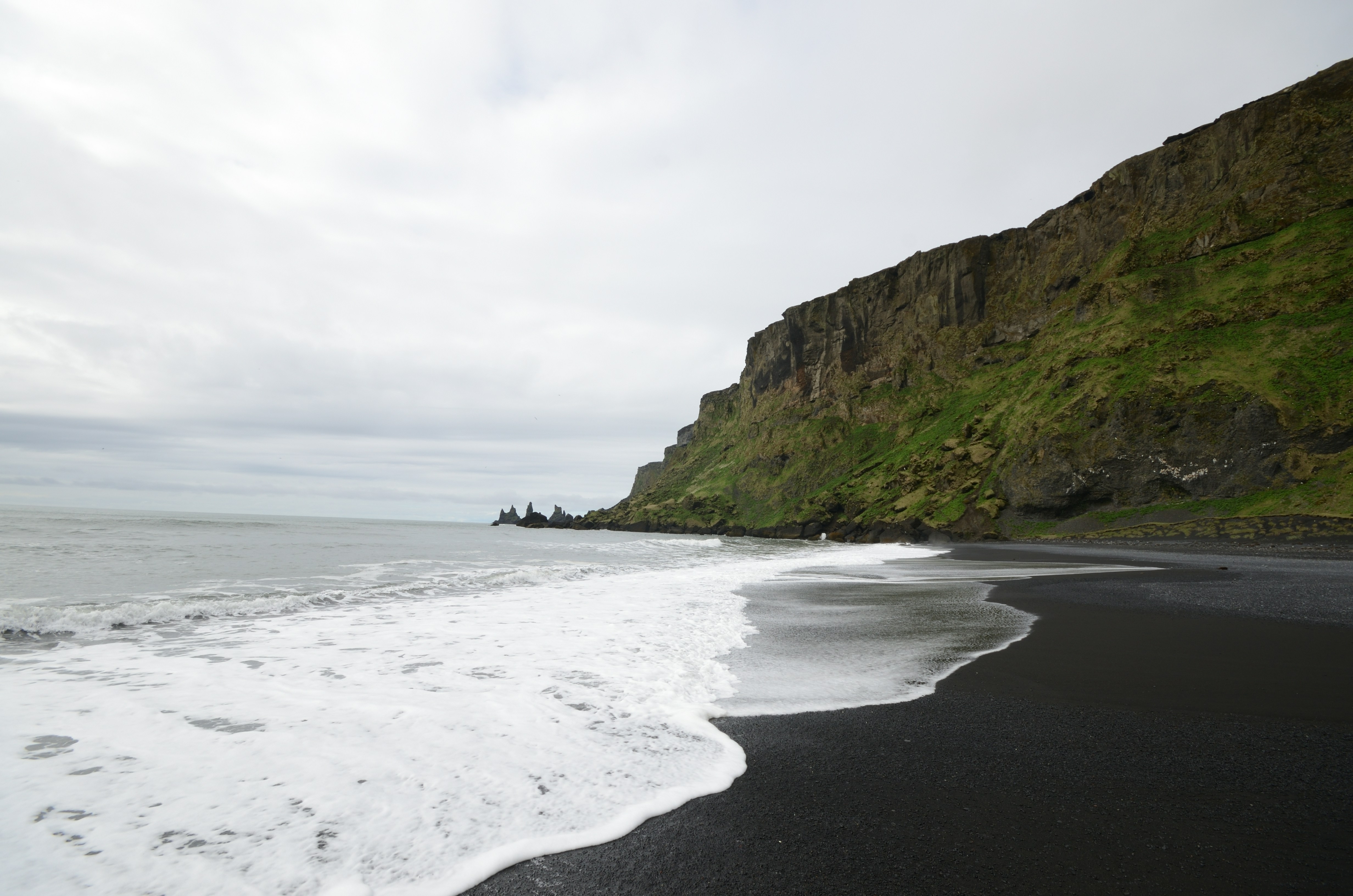 Ocean waves crashing onto Víkurfjara Black Sand Beach in South Iceland.