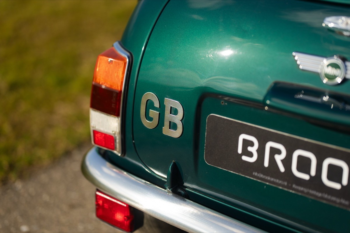 A close-up of a vintage car's rear, showcasing a green body, a "GB" decal, and a license plate reading "BROOK."