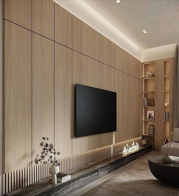 Modern living room with a flat-screen TV mounted on a wooden wall and soft lighting, featuring a sleek sofa.