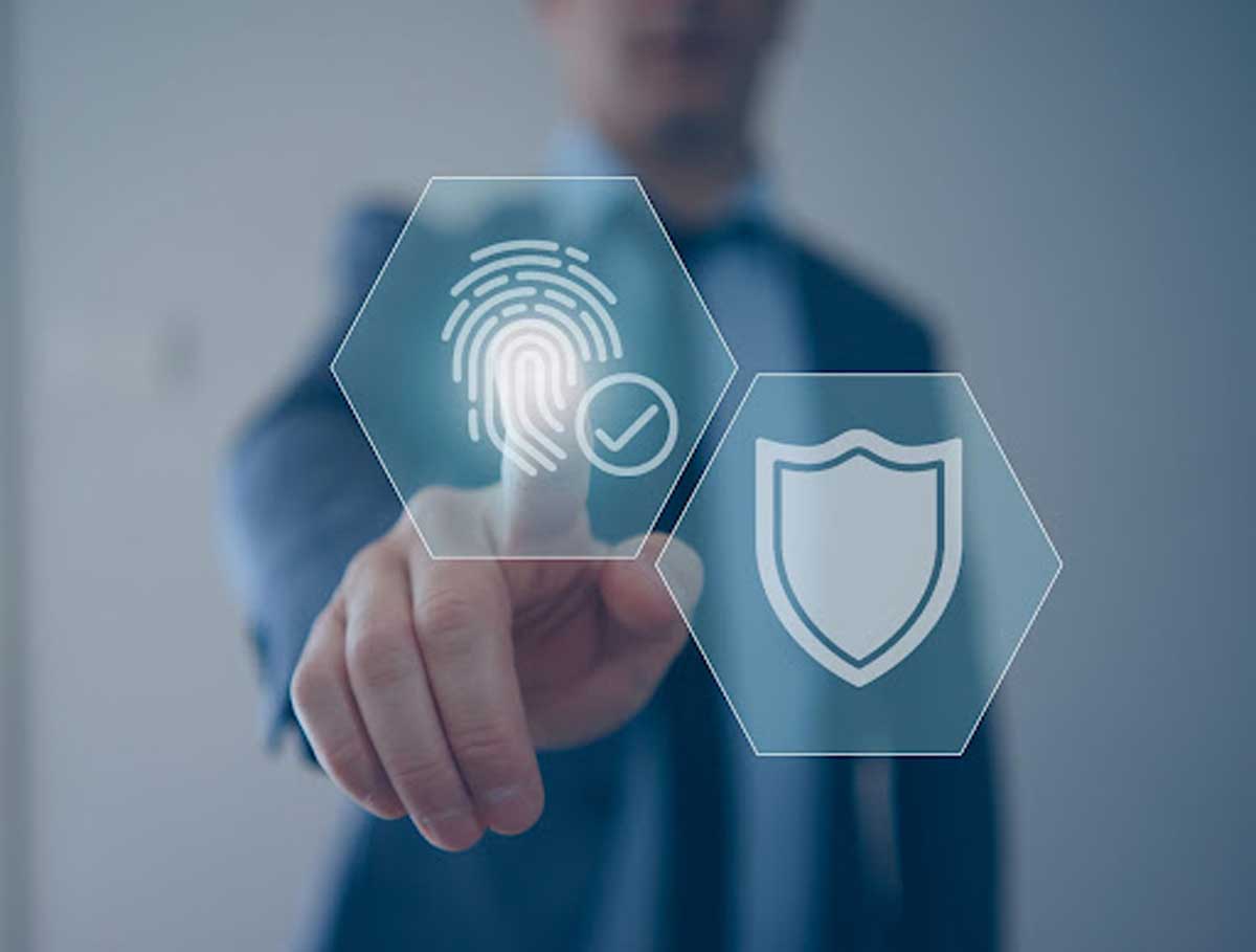 A person walks in front of large stone arches with dark doors, flanked by tall columns, in a historic building.