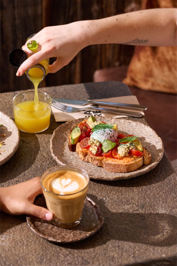 Vibrant brunch plate with avocado toast and fresh juice, showcasing Dhoom’s use of fresh ingredients and controlled culinary techniques applied to modern Indian cuisine.