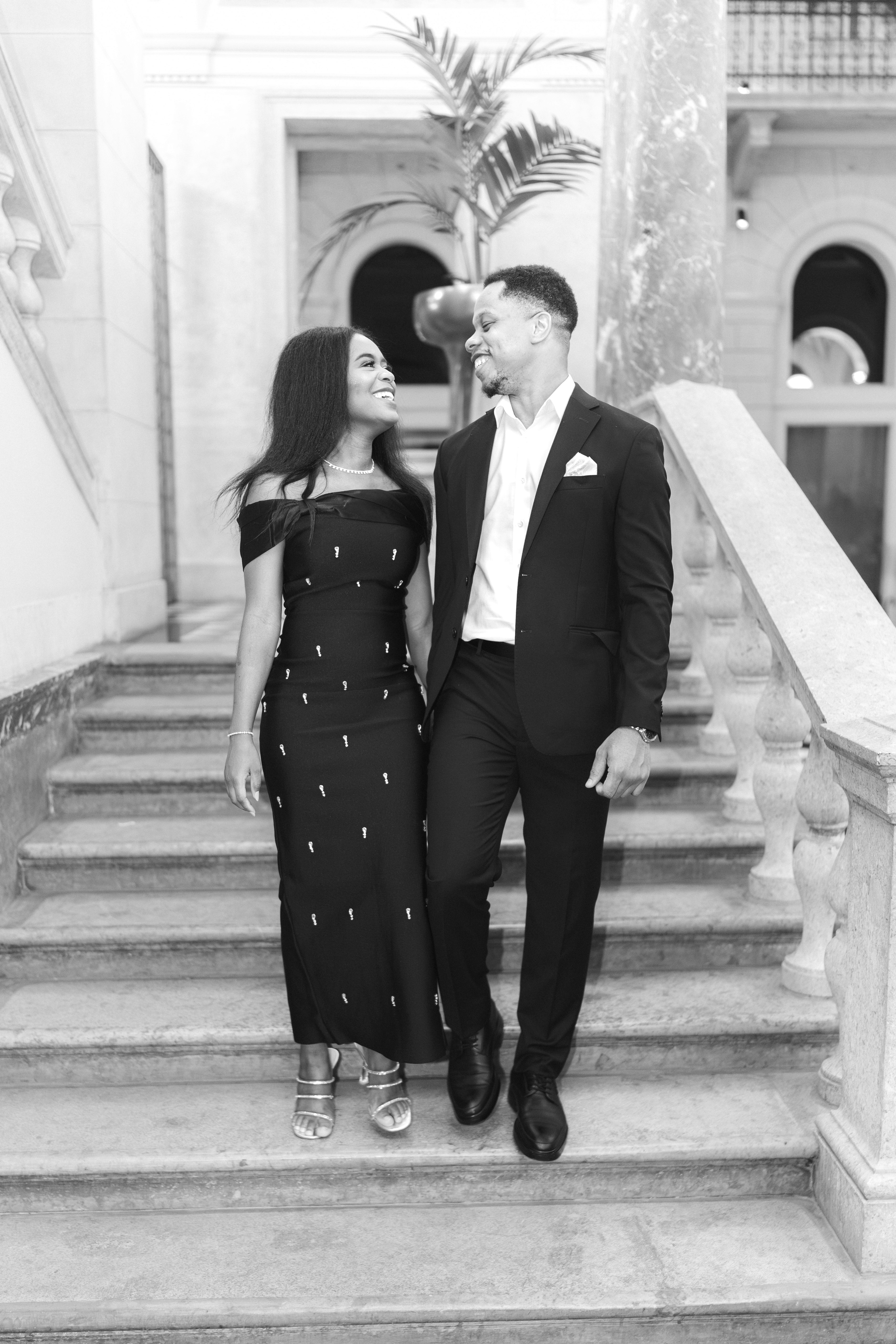 A beautifully set dining table with white tablecloth, cutlery, and fresh greenery in a cozy, well-lit space.