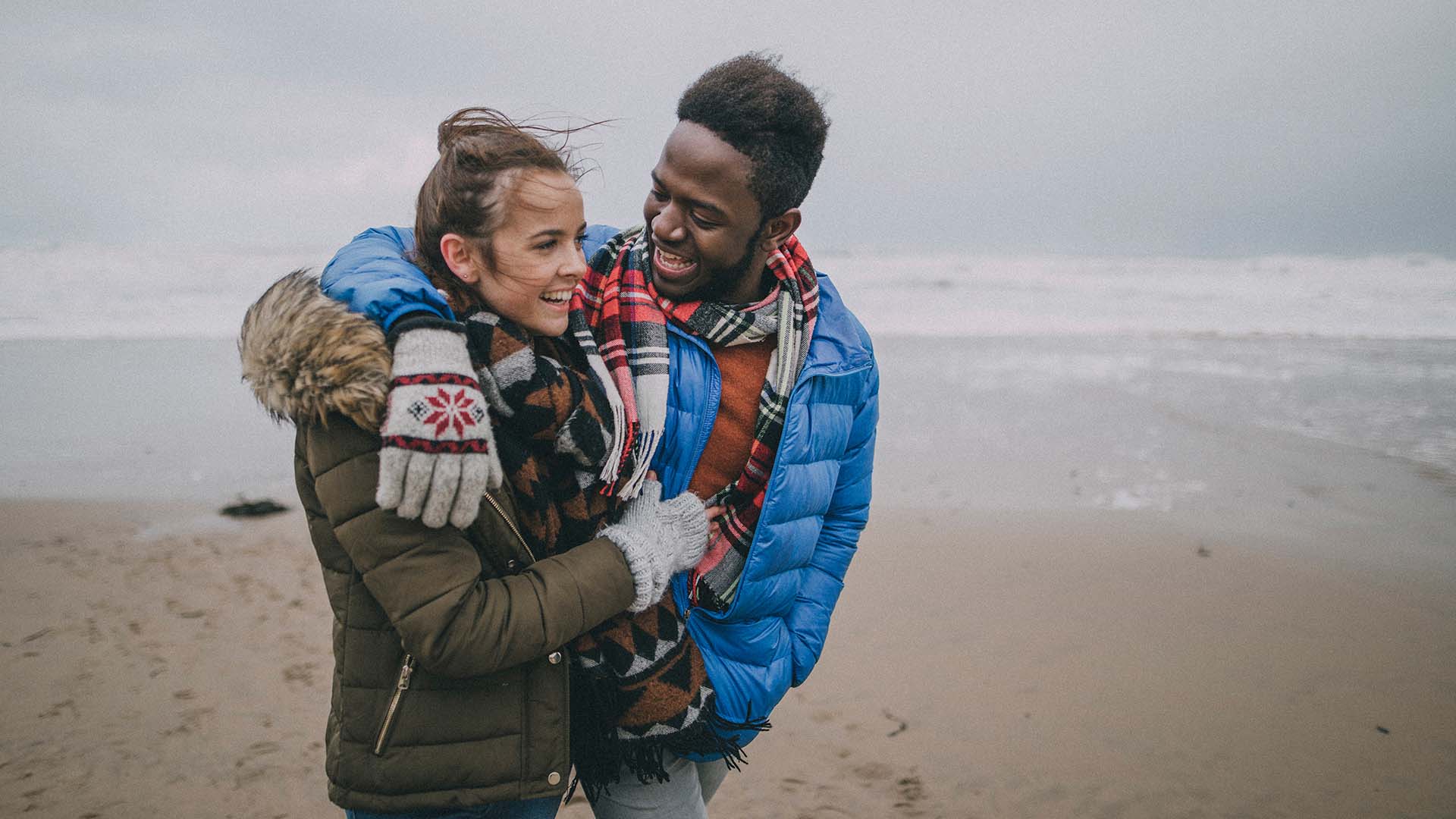 Image of a couple on a beach in the winter