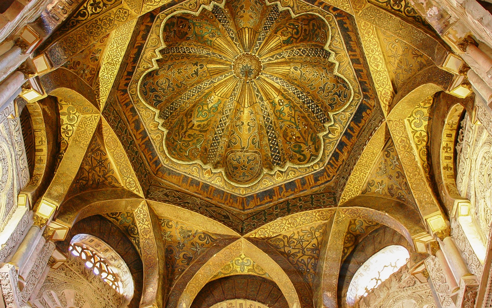 Ceiling of the Mosque-Cathedral of Córdoba with intricate gold and geometric designs.
