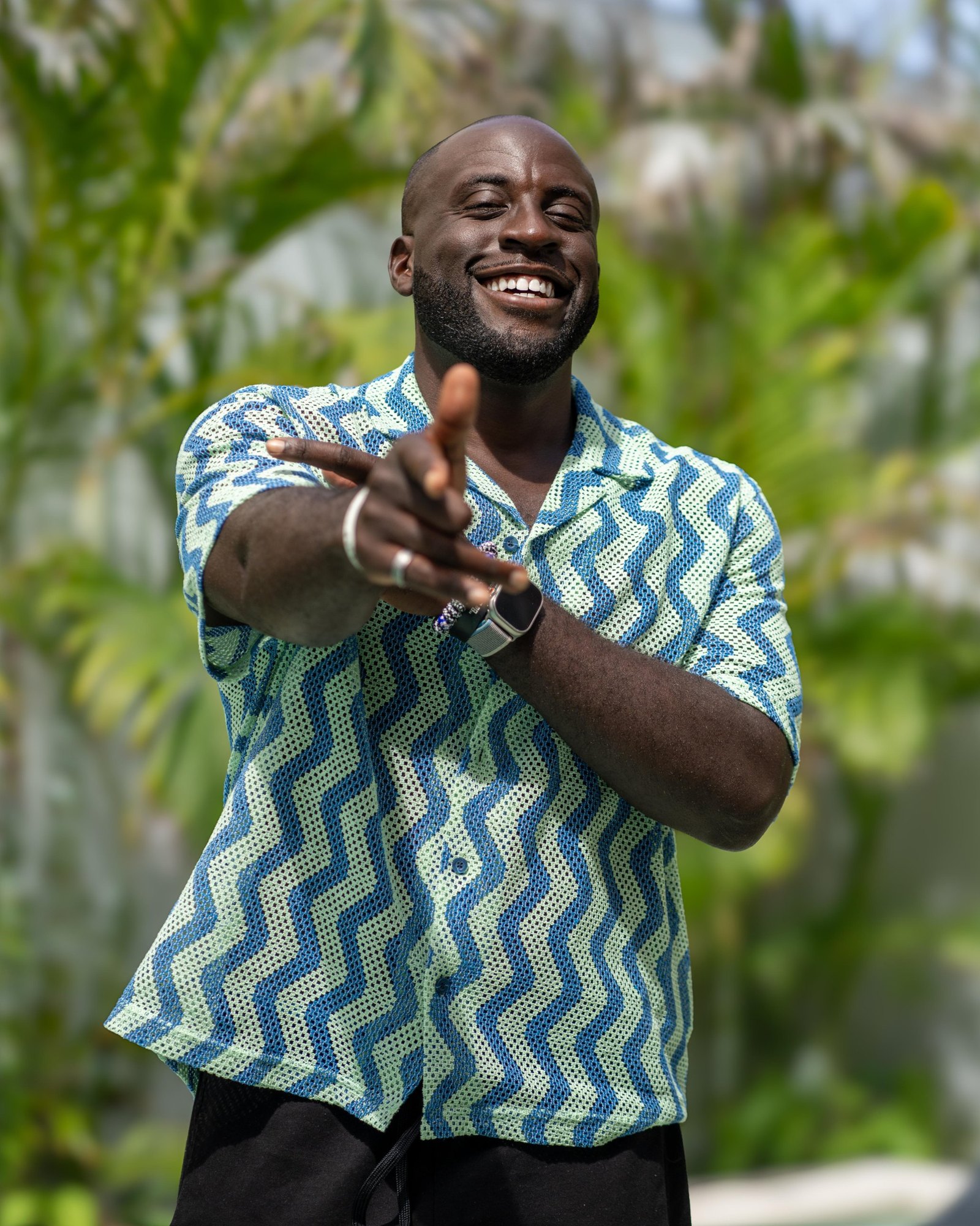 Jubril smiling and pointing at the camera