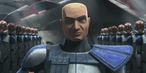 Captain Rex without a helmet smiling with clone troopers behind him