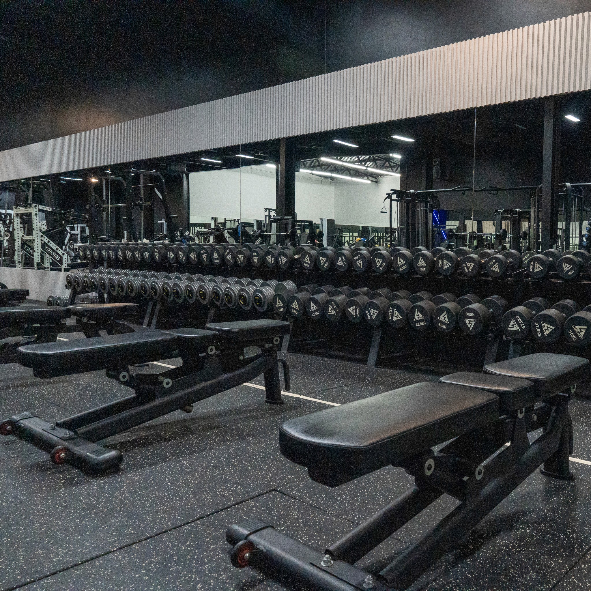 Functional training gear at Legacy Muscle Universe Koh Samui, with kettlebells and battle ropes in a dynamic fitness environment.