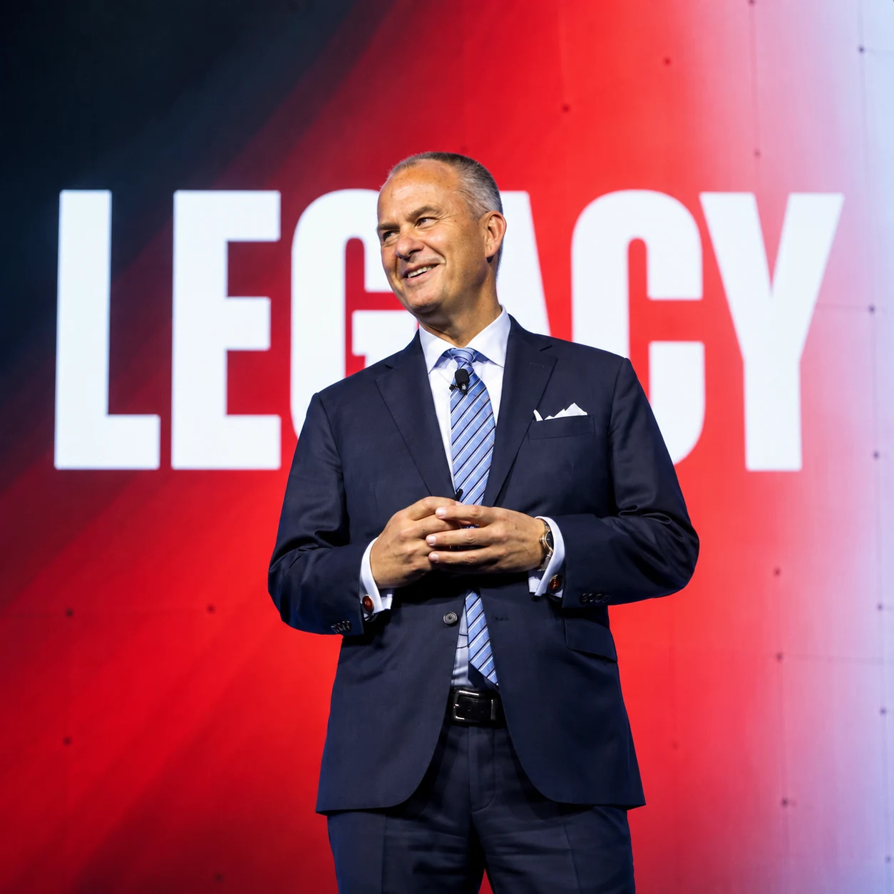 Michael Moe on stage in front of the word Legacy