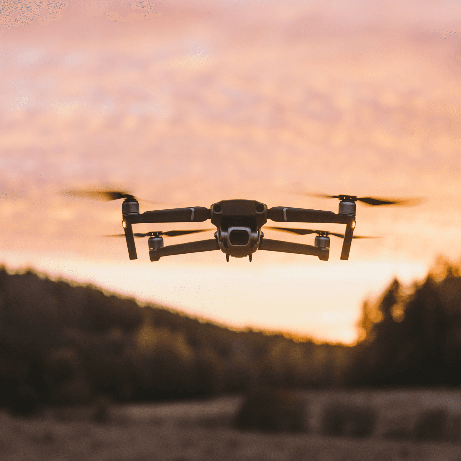 An image of a DJI Mini 4 Pro drone flying at sunset