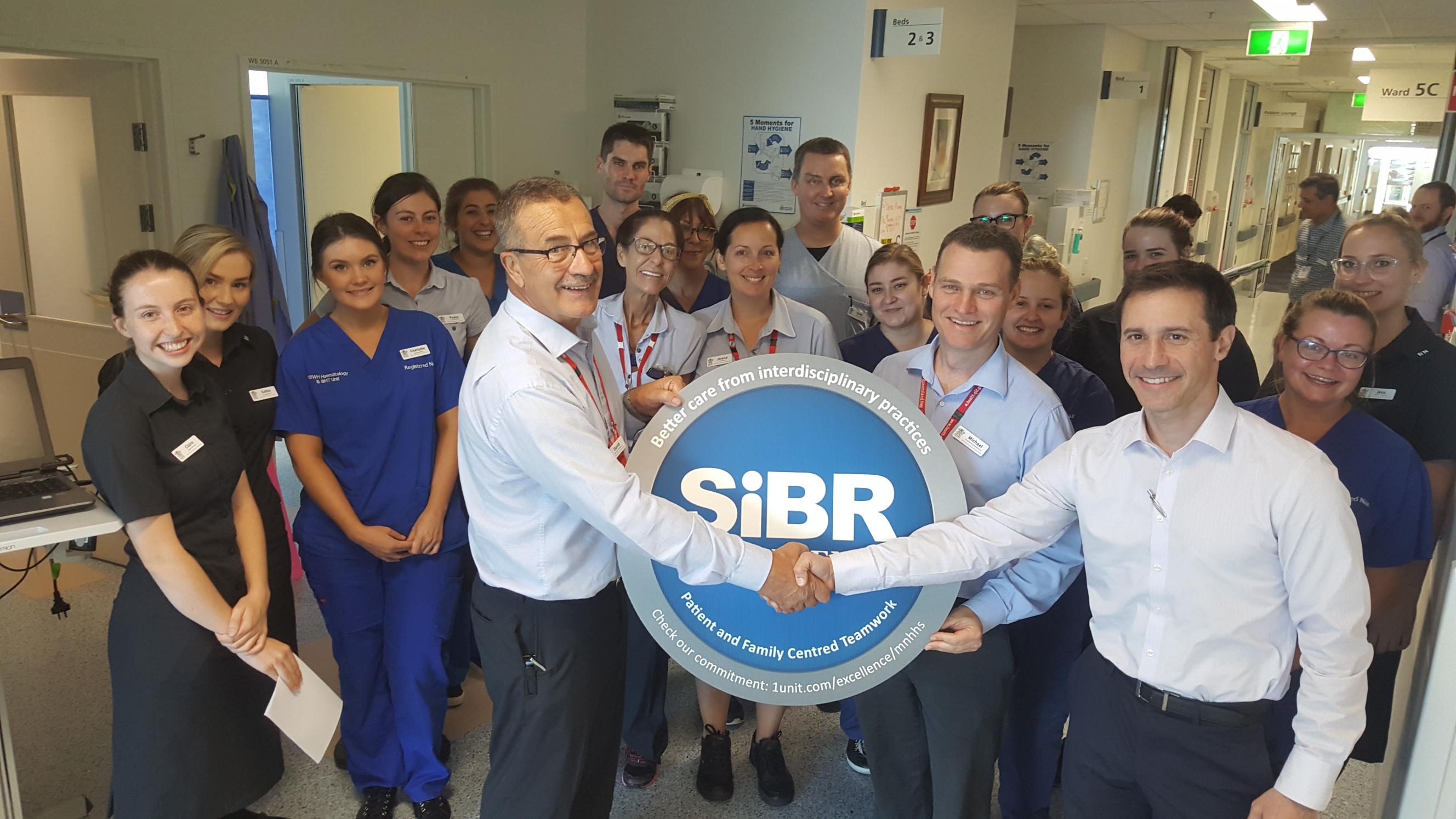1Unit team awarding hospital oncology team SIBR Certified status
