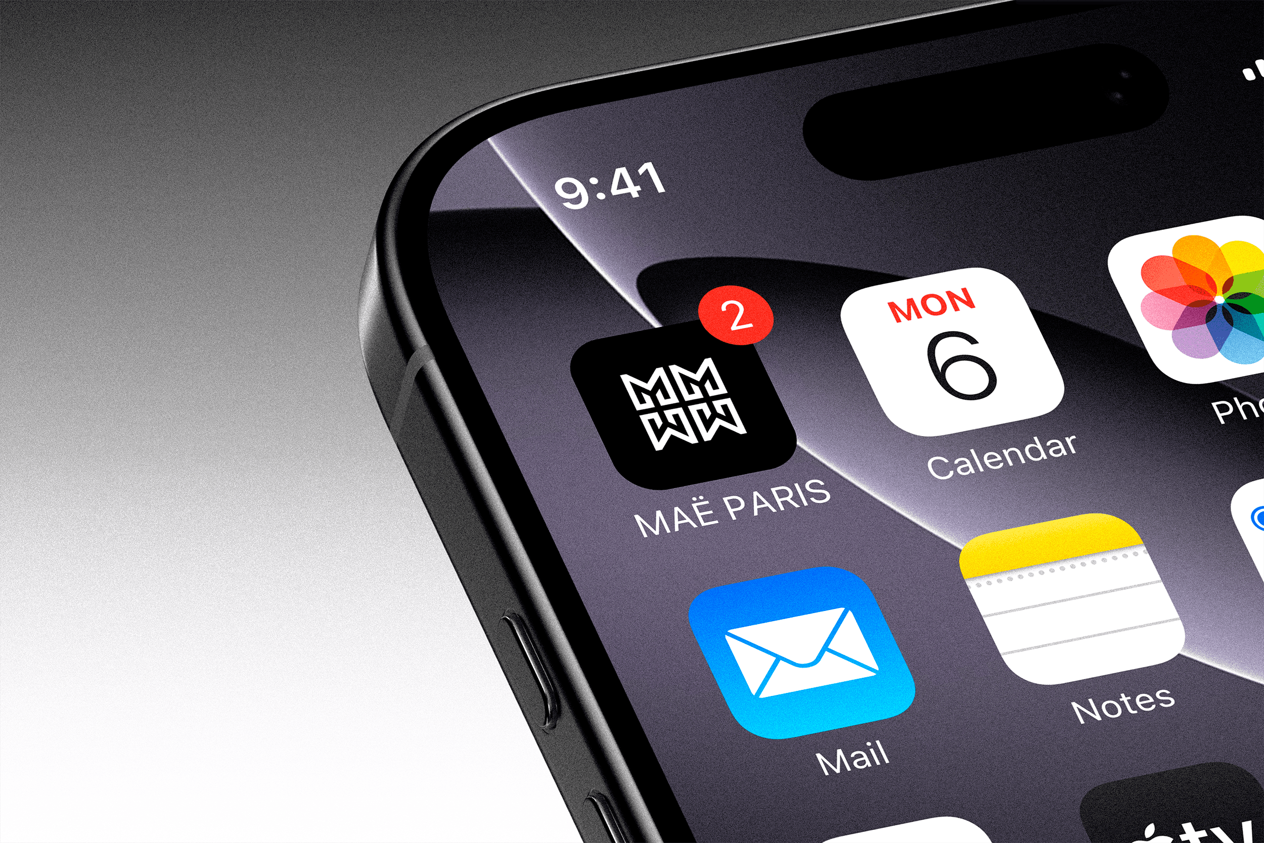 MAË PARIS luxury fashion mobile app interface displayed on an iPhone mockup showing brand identity