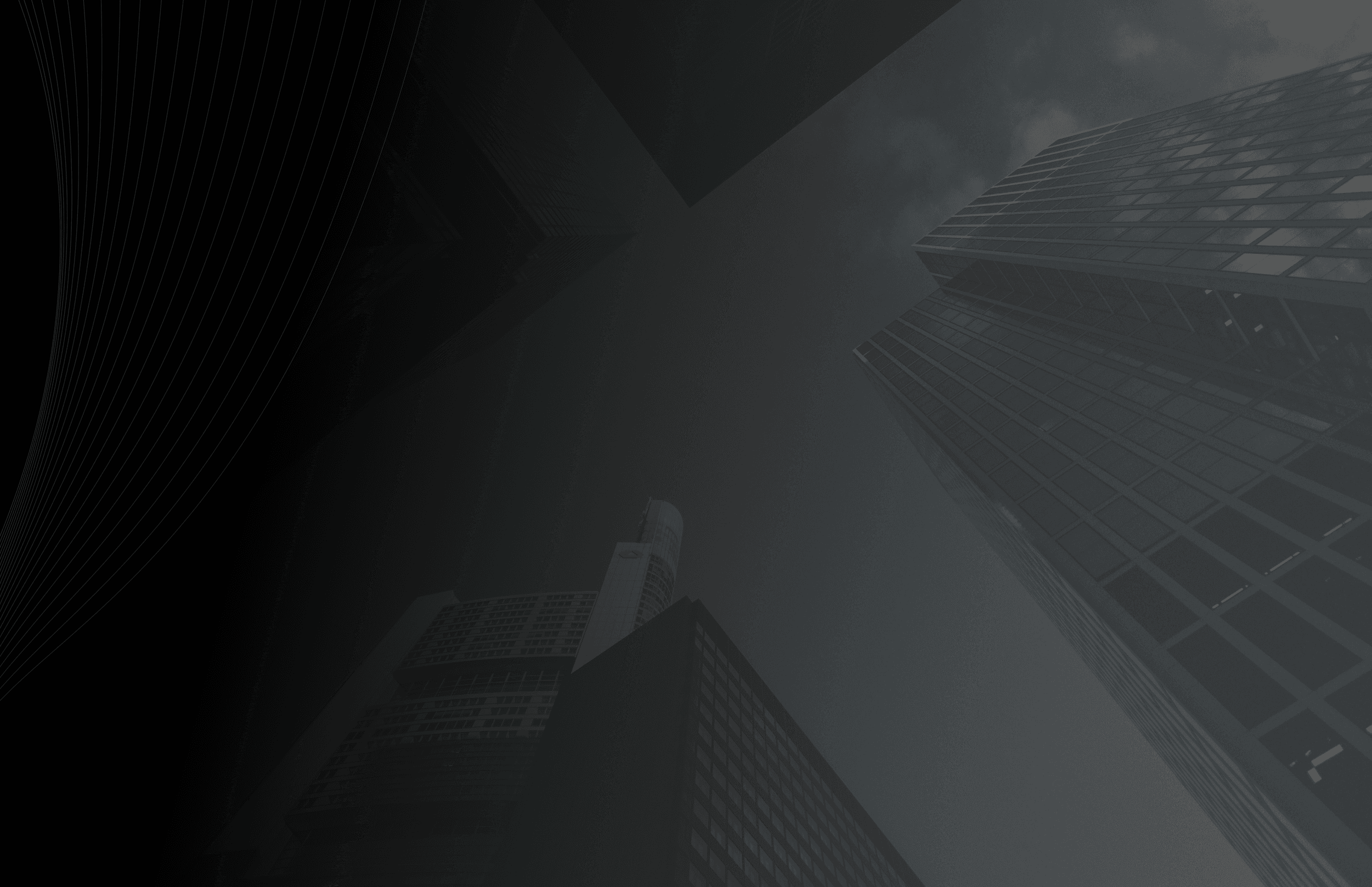 Low angle perspective of modern corporate skyscrapers and glass office towers against a dark sky.